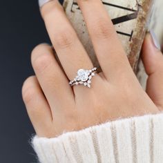 a woman's hand with a diamond ring on it