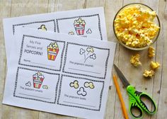 two printable popcorn cards next to scissors and a bowl of popcorn