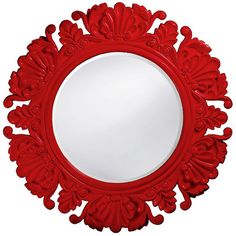 a red round mirror sitting on top of a white wall