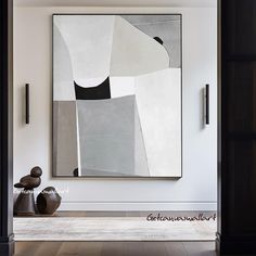 a large abstract painting hangs on the wall