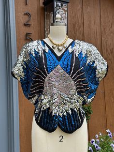 Thank You If You Favored One of My Items! You Will Receive 10% Off an Item of Your Choice, Unless It Is on Sale, CODE17. Thank You BUTTERFLY Sequin Top/Sequn Tops/Sequin Butterfly Top/80's Style Fashion/Sequin Clothing/Y2K Sequins/Spade Top/Mint Condition Circa 80's BUTTERFLY Style Sequin Top This is such an Awesome Y2K Top! It is Designed in the Shape of the 80's Butterfly Tops, but it is done with a New Image of a SPADE!  It is Designed on a Black Ground with Royal Blue and Silver Sequins.   W Sequin Clothing, Butterfly Tops, Rare Butterfly, Sequin Butterfly, Clothing Y2k, Black Ground, Butterfly Style, Sequin Outfit, Butterfly Top