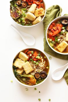 two bowls of soup with tofu and vegetables