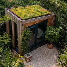 a tennis court with a green roof and plants growing on it's side wall