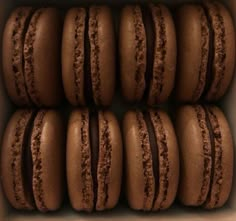 chocolate macaroons are arranged in a box on top of each other, ready to be eaten