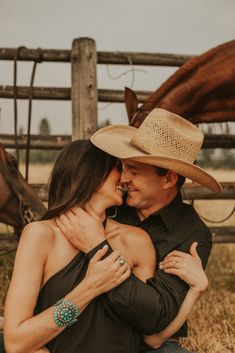 a man and woman in cowboy hats hugging each other