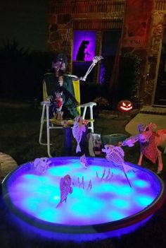 halloween decorations are displayed in the yard at night