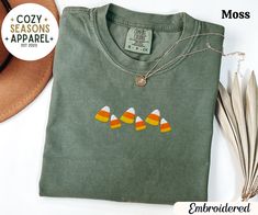 Embroidered Halloween Candy Corn Shirt Product Details - Embroidered - Unisex Relaxed Fit T-Shirt - Ultra soft Comfort Colors C1717 - Garment-dyed T-Shirt - Designed with high quality pre-shrunk combed and ring-spun cotton - Features a crewneck with shoulder to shoulder taping and side seams - Sewn-in twill label - The double-needle stitching throughout the tee makes it highly durable while the lack of side-seams helps the shirt retain its tubular shape. *Sizing and Colors - Please refer to sizi Fall Long Sleeve T-shirt With Machine Embroidery, Long Sleeve T-shirt With Machine Embroidery For Fall, Halloween Embroidered Cotton Tops, Halloween Long Sleeve Embroidered T-shirt, Halloween Cotton Embroidered Tops, Halloween Embroidered Long Sleeve T-shirt, Embroidered Cotton Tops For Halloween, Embroidered Long Sleeve T-shirt For Halloween, Embroidered Short Sleeve T-shirt For Fall