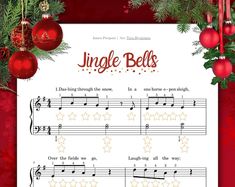 a sheet music page with christmas decorations and ornaments around it, including red baubs