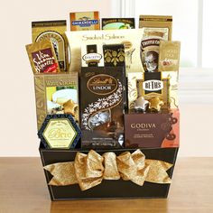 a large gift basket filled with chocolates, coffee and candies for someone special