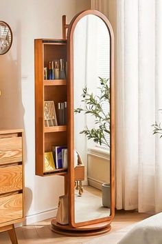 a large mirror sitting on top of a wooden shelf next to a bed in a room