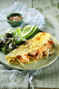 an omelet with shrimp and lettuce on a plate