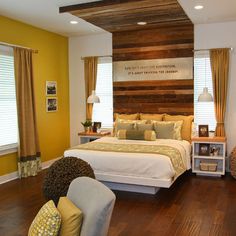 a bedroom with yellow walls and wood floors