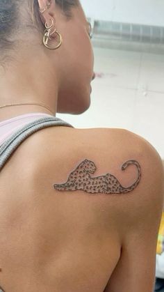 a woman with a cheetah tattoo on her back