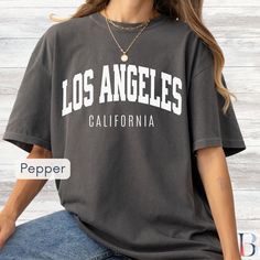 Los Angeles T-Shirt, West Coast Comfort Colors Unisex Shirt, Vintage LA College Style Tee, Oversized, Tshirt, Retro Los Angeles California  Step into the sun-soaked streets of LA with our "Los Angeles, California" Comfort Colors 1717 garment-dyed t-shirt. Designed with a vintage feel and bold college block text, this premium tee is perfect for capturing the timeless, cool, and laid-back style of the City of Angels. 🎁 This vintage 'Los Angeles, California' tee makes a great gift for LA natives, Oversized Graphic Tee For College, Oversized Crew Neck T-shirt For College, Oversized Screen Print T-shirt For College, Oversized Graphic Print Tops For College, College Tops With Text Print And Relaxed Fit, Oversized Text Print Top For College, Text Print Relaxed Fit Tops For College, Relaxed Fit Text Print Top For College, College Text Print Top With Relaxed Fit