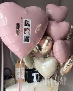 a bunch of heart shaped balloons on top of a table