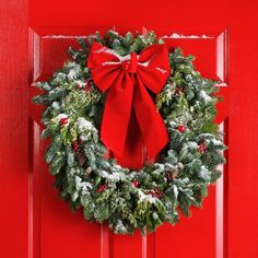 a red door with a wreath on it