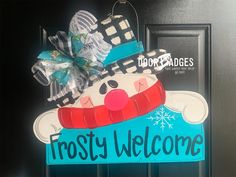 a frosty welcome sign hanging on the front door