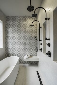 a white bath tub sitting next to a walk in shower