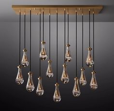 a bunch of light bulbs hanging from a wooden ceiling fixture in a room with black walls