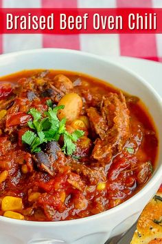 a white bowl filled with chili and meat