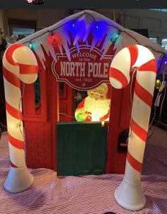 the north pole booth is decorated with candy canes