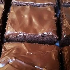 chocolate brownies with frosting on top are arranged in rows