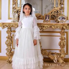 Traditional Catholic First Communion Dress and Veil Handcrafted  100% Cotton  Italian Lace When it comes to selecting the perfect First Communion dress, nothing compares to the exquisite beauty of Italian Lace. This timeless fabric adds an elegant touch to any 1st Communion dress, making it a cherished keepsake for years to come. Italian Lace is renowned for its intricate patterns and delicate craftsmanship. Each dress is carefully crafted with attention to detail, ensuring that every stitch is flawless. The result is a First Holy Communion dress that exudes grace and sophistication. Not only does Italian Lace create a stunning aesthetic, but it also symbolizes the significance of this sacred occasion. The purity and innocence represented by the First Communion are beautifully reflected in Long Sleeve Ruffled Dress For First Communion, Elegant Long Sleeve Confirmation Dress, Elegant Long Sleeve Dress For First Communion, Fitted Gown For Confirmation With Long Sleeves, Fitted Long Sleeve Gown For Confirmation, Fitted Ruffled Dress For Confirmation, Fitted Ruffle Dress For Confirmation, Long Sleeve Confirmation Dress With Lace Trim, White Long Sleeve Confirmation Dress