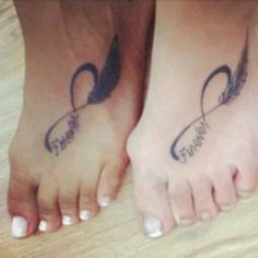 two people with tattoos on their feet and one has an arrow in the shape of a heart