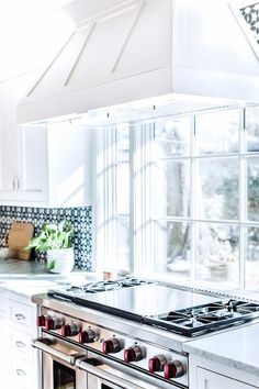 a stove top oven sitting inside of a kitchen