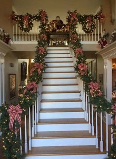 the stairs are decorated with christmas garlands and bows