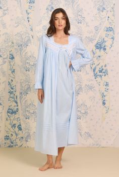 Our best selling Dobby Stripe Collection is now available with a coordinating button front robe. This can be worn alone as a nightie or as a robe to make a perfect set with the Dobby Stripe Ballet Gown. A clean and classic look, this 100% cotton robe is designed with a delicate dobby stripe, accented by venise lace at the neckline, pintucks at the neckline and skirt, and a full button front of shimmery akoya buttons. The Robe is 52" inches long and has ruffle elastic sleeves and side seam pocket Light Blue Summer Nightgown, Ballet Gown, Long Blue Cotton Robe, Blue V-neck Nightgown For Sleep, Blue V-neck Nightgown For The Beach, Blue V-neck Nightgown, Gown Simple, Eileen West, Elastic Sleeves