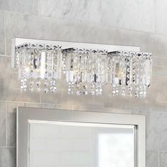 a bathroom vanity with a mirror and lights above it