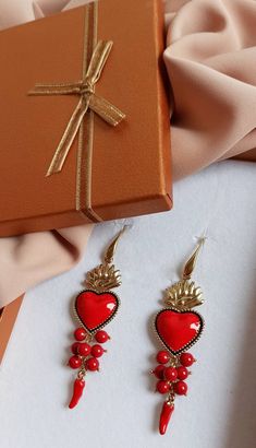 Religious earrings made of: - Enamelled Brass Sacred Heart (40 mm x 23 mm); - Smooth stones (6 mm), red color; - Brass italian horns; - Brass open hooks. Lenght : 8,5 cm / 3,35 inches * SHIPPING * Your order will be shipped within 1-3 business days from your purchase. You can choose between 2 shipping methods: STANDARD MAIL (NOT TRACEABLE) It is a cheap and fast shipping method, but NOT TRACEABLE. Chapeau Atelier is not responsible for any postal disruptions, delays or losses. REGISTERED MAIL (T Italian Horn, Earrings Red, Sacred Heart, Heart Jewelry, Heart Earrings, X 23, Red Color, Dangle Drop Earrings, Brass