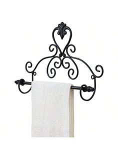 a towel rack with two towels hanging from it's sides and an iron scroll design