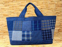 a blue tote bag sitting on top of a bamboo mat