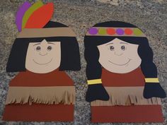 two paper cut outs with people wearing native american clothing and feathers on top of them