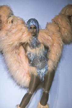 a woman in a fur coat and headdress