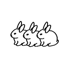 three rabbits sitting next to each other on top of a white surface with black ink