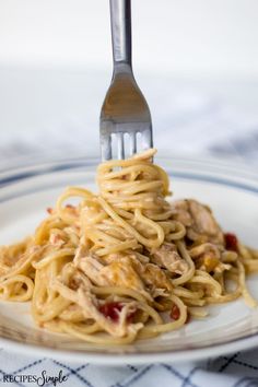 a fork is stuck into some pasta on a plate