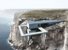 a concrete structure on top of a cliff by the ocean with an open window to let in light