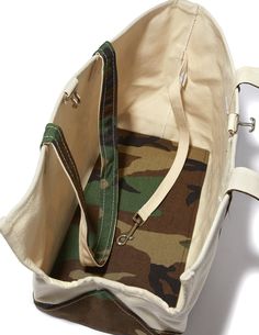 a camo bag is shown with the zipper open to show it's contents