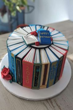 a birthday cake made out of books on a plate