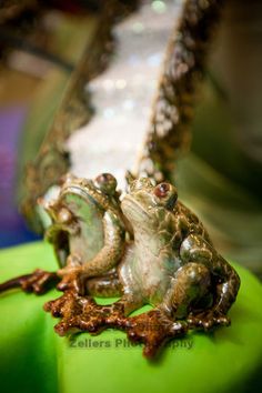 two frog figurines sitting on top of each other