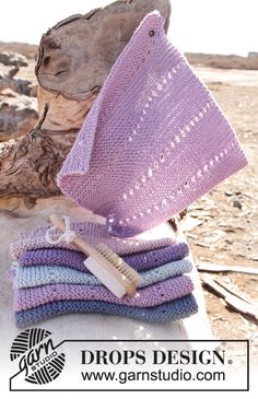 a pile of crocheted towels sitting on top of a tree stump