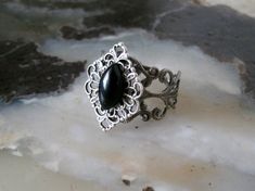 This beautiful sterling silver plated filigree ring has a sterling silver plated filigree setting with black obsidian stone. Adjustable. Gothic Formal Adjustable Rings, Gothic Style Adjustable Rings For Formal Occasions, Gothic Adjustable Rings For Formal Occasion, Adjustable Gothic Style Rings For Formal Occasions, Gothic Oval Rings For Formal Occasions, Silver Gothic Gemstone Jewelry, Elegant Antique Silver Cabochon Jewelry, Antique Silver Adjustable Victorian Ring, Adjustable Antique Silver Victorian Ring