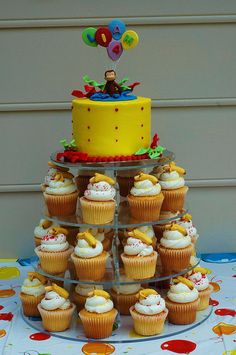 a cake and cupcakes are arranged on a table