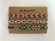 three braided bracelets on top of a brown card