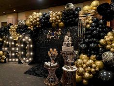 a room filled with lots of black and gold balloons that spell out the word 40