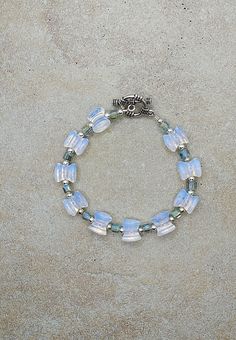 "one of a kind bracelet, opalite beaded bracelet, Sterling silver opalite bracelet, October birthstone bracelet Natural opalite stone, sterling silver and crystal handmade bracelet, 7.5\" 10mm by 8mm bow shape beads are opalite. Crystals are half blue, half clear 4mm cubes. sterling silver beads are 3mm round. Toggle clasp is pewter. Check out my other jewelry at https://loveofjewelryshop.etsy.com" Adjustable Beaded Opal Bracelet, Adjustable Hand-strung Opal Jewelry, Hand-strung Silver Czech Glass Jewelry, Adjustable Opal Spiritual Bracelet, Opalite Bracelet, Opalite Crystal, Birthstone Bracelet, Toggle Bracelet, Birthstone Bracelets