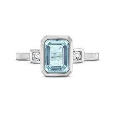 This Aquamarine Diamond Bezel Ring features an emerald cut aquamarine weighing approimately 1.60 carats accented with 0.08 carats of round brilliant cut diamonds on each side. Emerald Cut Aquamarine Rings With Gemstone Accents, Octagon Aquamarine Ring With Accent Stones, Octagon Aquamarine Rings With Accent Stones, Aquamarine Rings With Accent Stones In Octagon Shape, Aquamarine Octagon Rings With Accent Stones, Emerald Cut Aquamarine Diamond Ring With Center Stone, White Gold Topaz Ring With Diamond Accents, Emerald Cut, Emerald Cut Topaz Ring With Diamond And Gemstone Accents, Emerald-cut Aquamarine Ring In White Gold